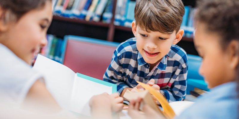 cute-little-kids-reading-books-in-library-XYN7H5T