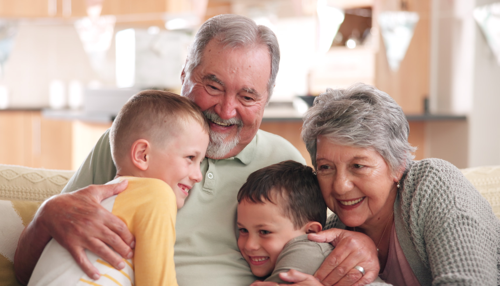 Grandparents and grandkids hugging and laughing