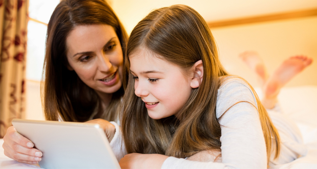 Mother and daughter learn Greek for kids on tablet