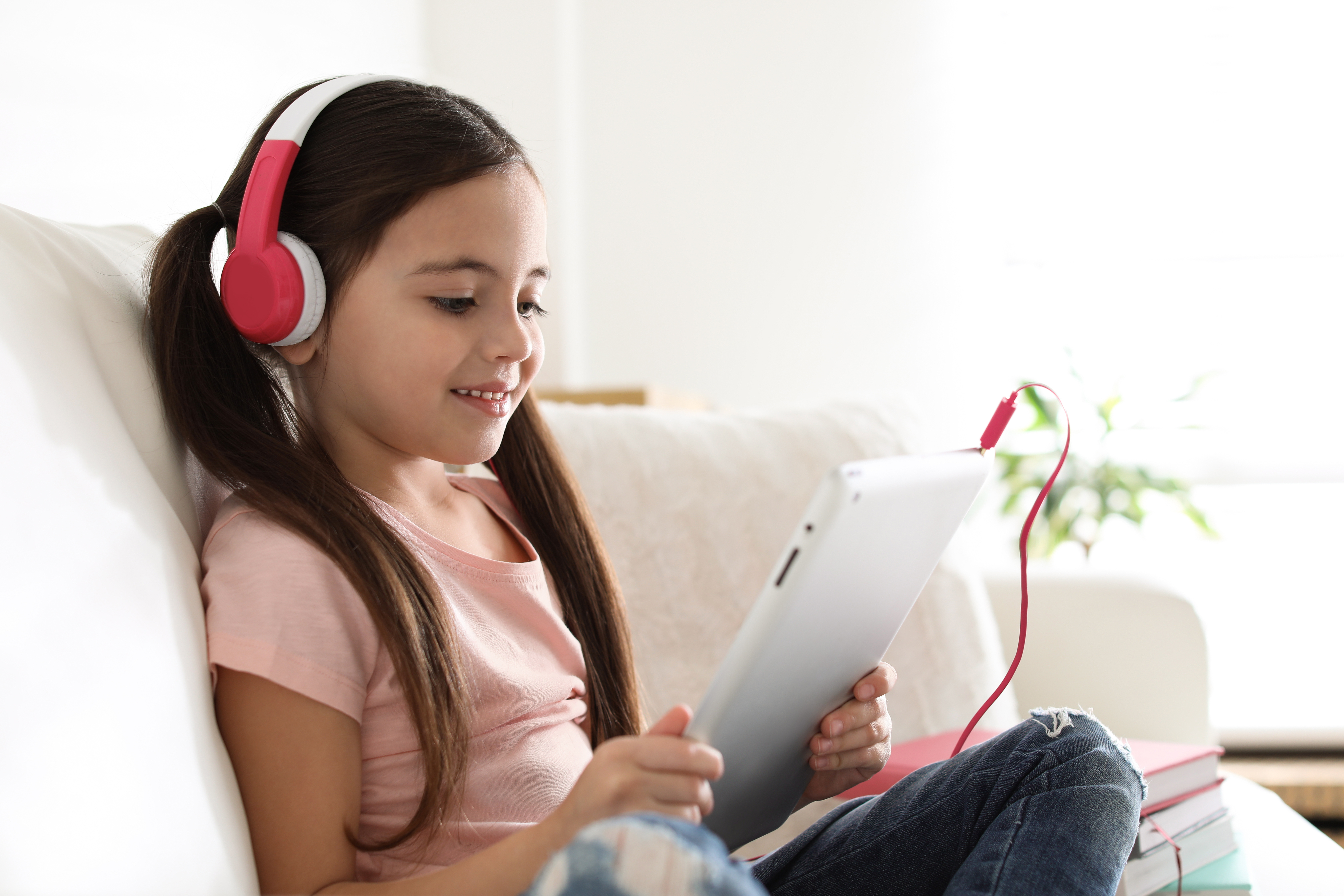 Young student smiling while studying on her tablet